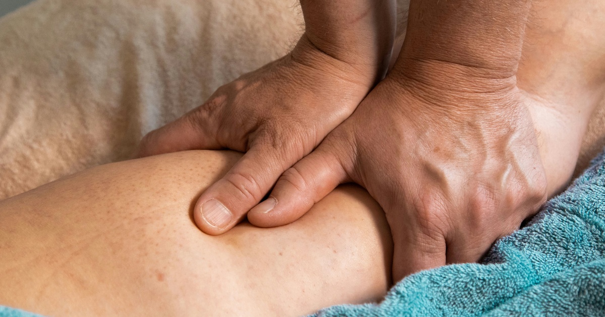 Physical therapist guiding a patient through a rehabilitation exercise